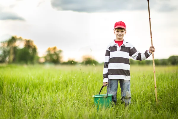 Young boy fishing in a river — Stock Photo, Image