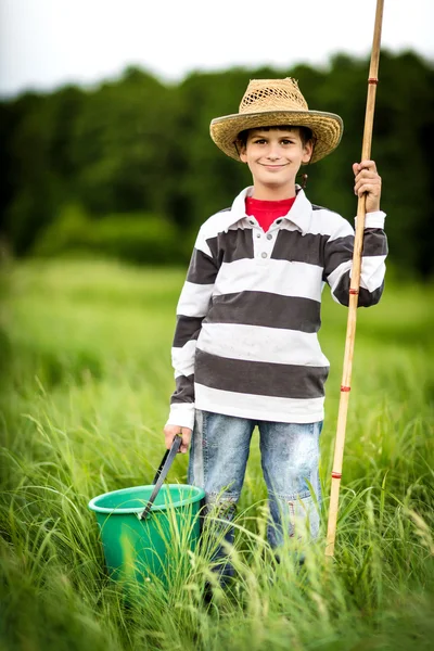Young boy fishing in a river — Stock Photo, Image