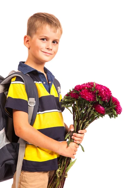 Skolpojke håller blommor. tillbaka till skolan Stockfoto