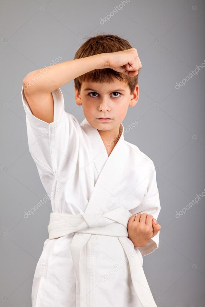 Karate boy in white kimono fighting