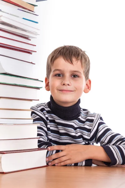 Skolpojke och en hög med böcker — Stockfoto