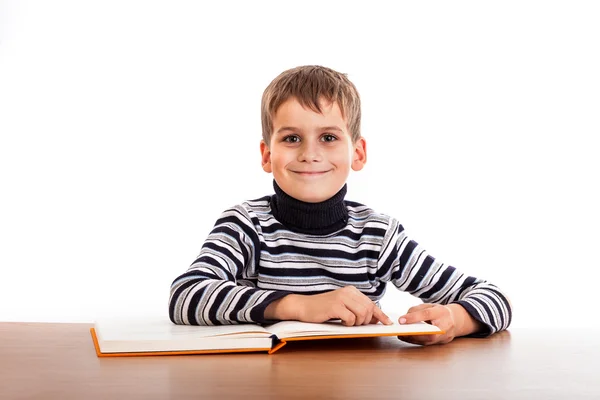 Cute schoolboy is reading a book — Stock Photo, Image