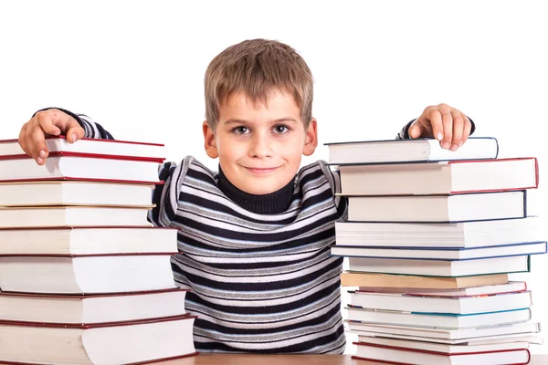 Schoolboy and a heap of books — Stock Photo, Image