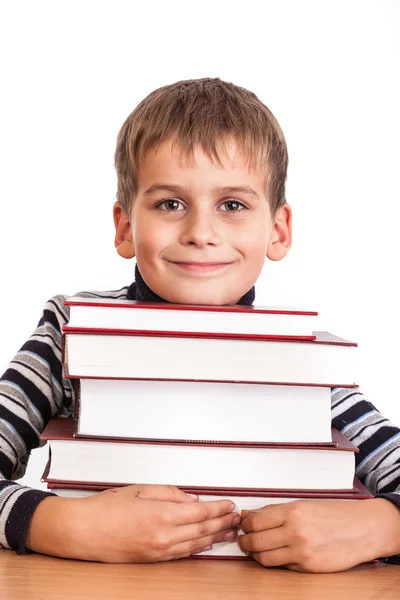 Schoolboy and a heap of books — Stock Photo, Image
