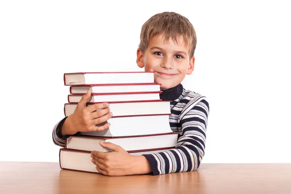 Školák a hromadu knih — Stock fotografie