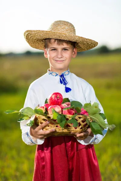 Happy farmer boy hold Organic Apples in Autumn Garden — Stock Photo, Image