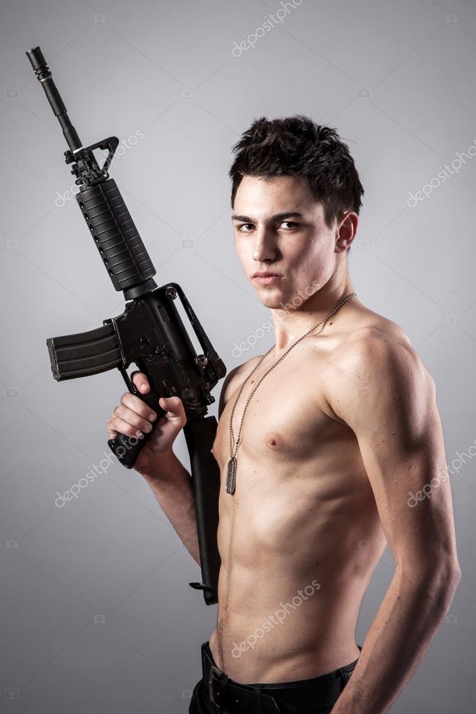 Handsome soldier is holding a rifle Stock Photo by ©bloodua 32561423