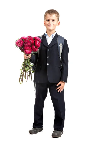 O estudante está a segurar flores. De volta à escola — Fotografia de Stock