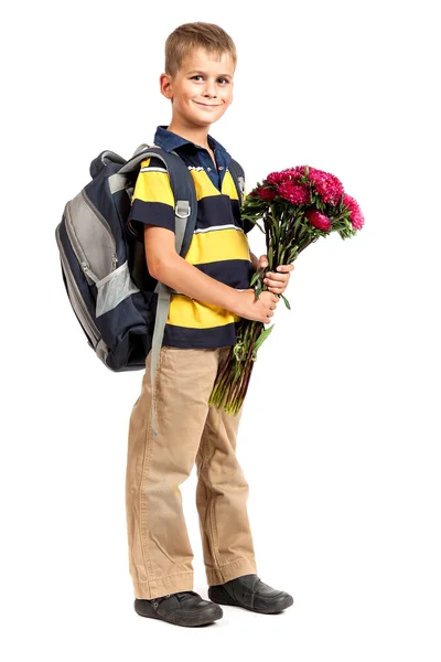 Schoolboy está segurando flores — Fotografia de Stock