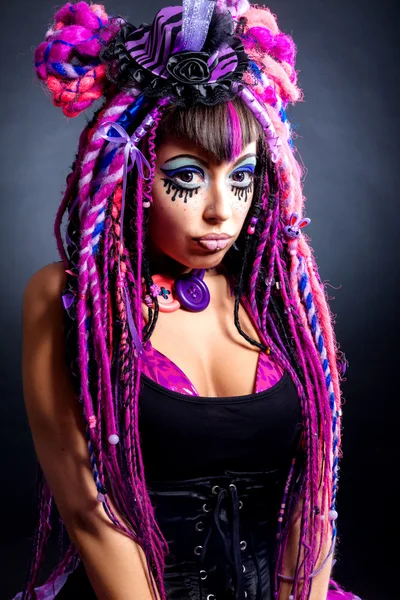 Portrait of a woman with multicolored dreadlocks and stylish mak — Stock Photo, Image