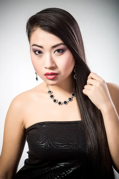 Beautiful brunette Asian woman with long black hair — Stock Photo, Image