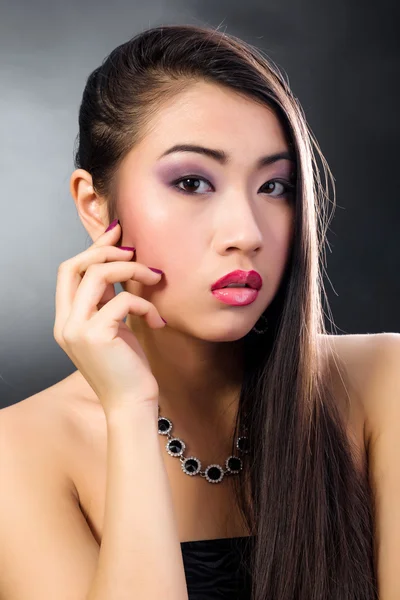 Beautiful brunette Asian woman with long black hair — Stock Photo, Image