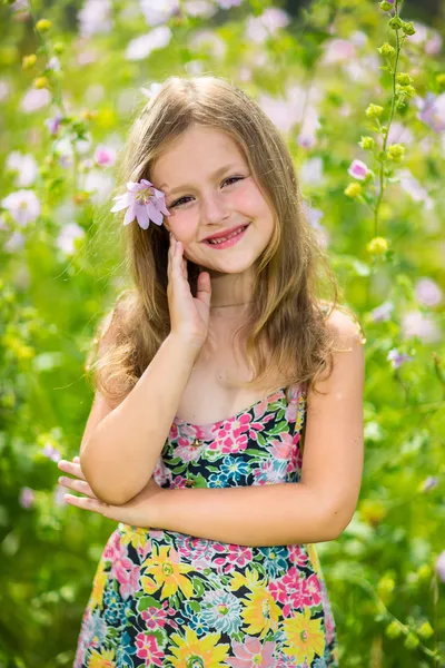 Portrait of a little girl in wreath of flowers — Stock Photo, Image