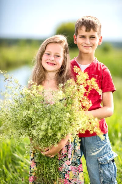 Våren. Pojke ger flickan en bukett blommor . — Stockfoto