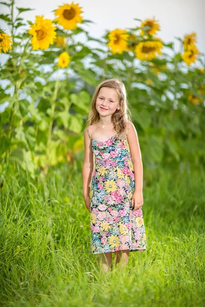 Portrait of a little girl in wreath of flowers — Stock Photo, Image