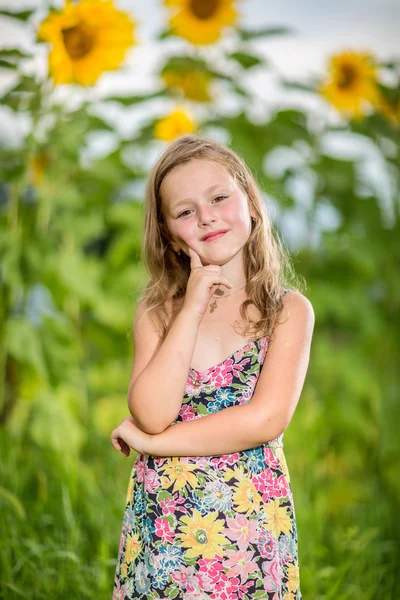 Portrait of a little girl in wreath of flowers — Stock Photo, Image