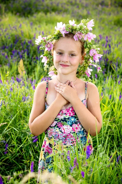 Portrait of a little girl in wreath of flowers — Stock Photo, Image