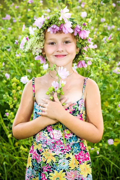 Portrait of a little girl in wreath of flowers — Stock Photo, Image