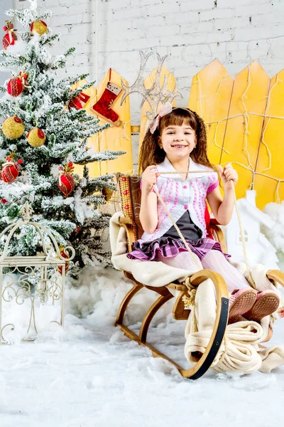 Little girl with gifts under the Christmas tree — Stock Photo, Image