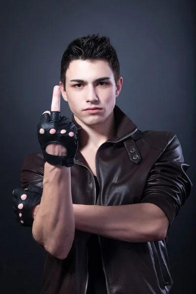 Young man is showing a middle finger — Stock Photo, Image