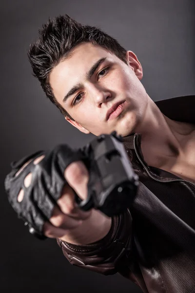 Serious man with a gun — Stock Photo, Image