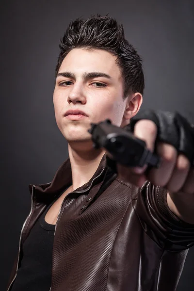 Serious man with a gun — Stock Photo, Image