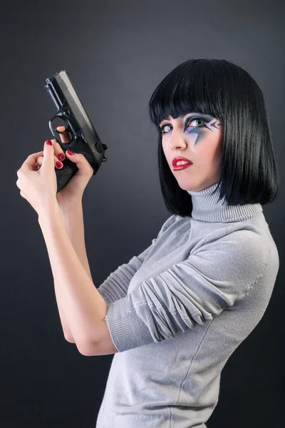 Beautiful woman with a gun — Stock Photo, Image