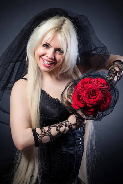 Portrait of a black widow in grief  with flowers — Stock Photo, Image