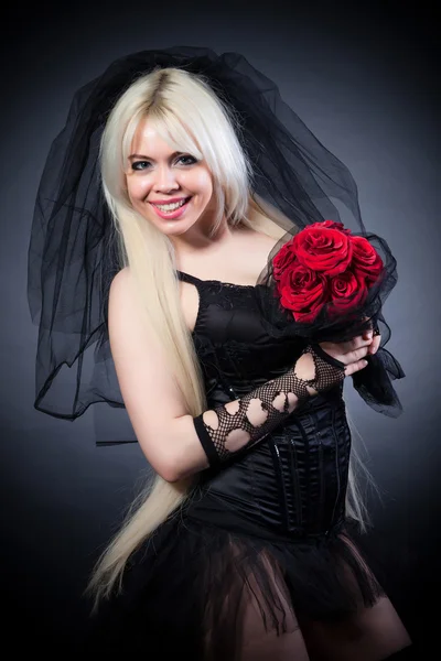 Portrait of a woman in black with flowers — Stock Photo, Image