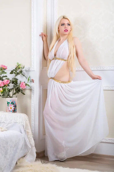 Blonde vrouw in een witte jurk — Stockfoto