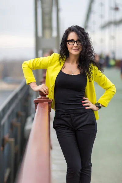 Menina bonita está em uma ponte ao ar livre — Fotografia de Stock