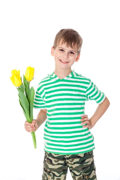 Jovem menino segurando tulipas amarelas — Fotografia de Stock