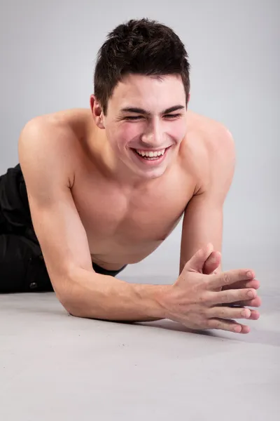 Healthy muscular young man on grey background — Stock Photo, Image