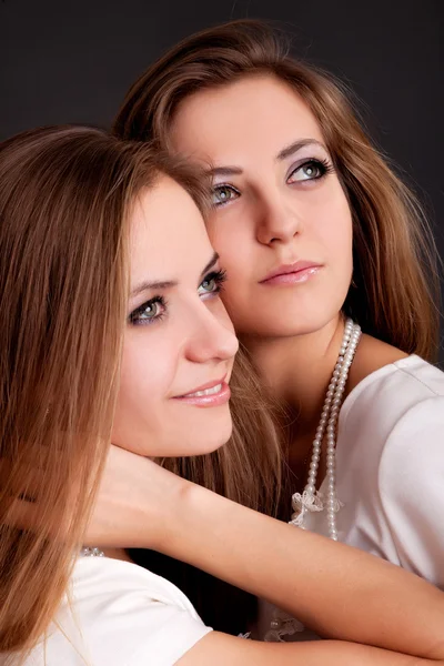 Two beautiful girls twins, isolated on black — Stock Photo, Image