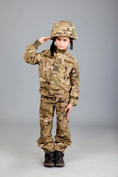 Saluting soldier. Young boy dressed like a soldier — Stock Photo, Image