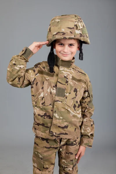 Saluting soldier. Young boy dressed like a soldier — Stock Photo, Image