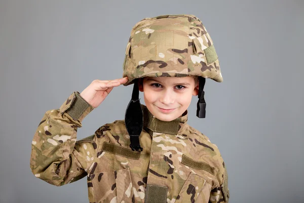 Saluting soldier. Young boy dressed like a soldier — Stock Photo, Image