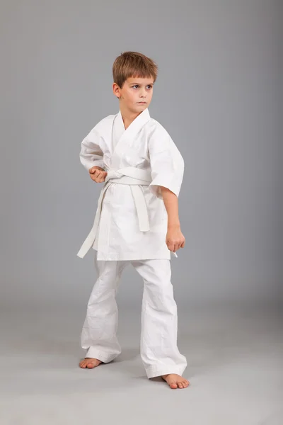 Karate boy in white kimono fighting — Stock Photo, Image