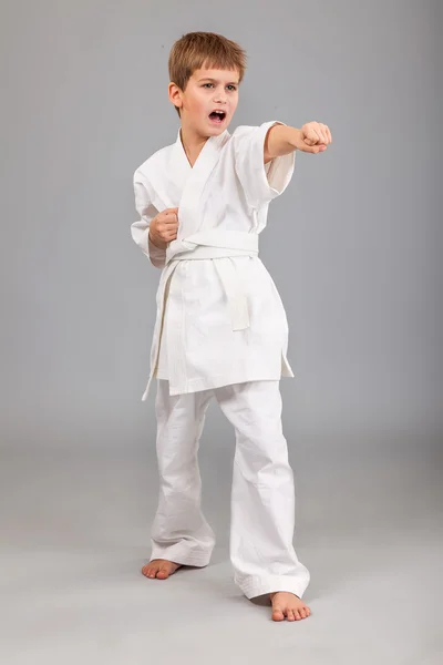 Karate boy in white kimono fighting — Stock Photo, Image