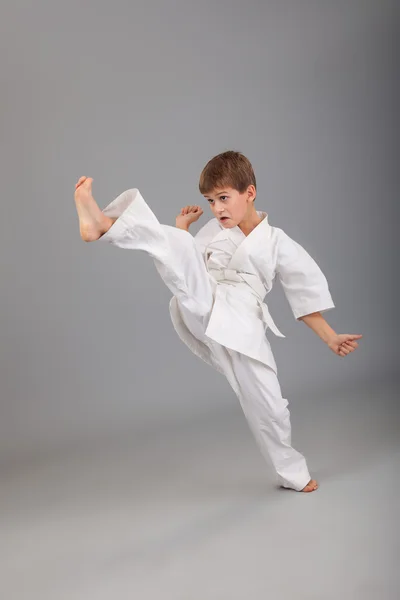 Karate boy in white kimono fighting — Stock Photo, Image