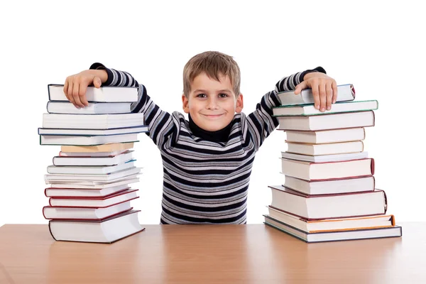 Schoolboy and a heap of books — Stock Photo, Image