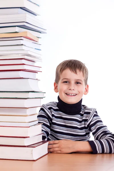 Un écolier et un tas de livres — Photo