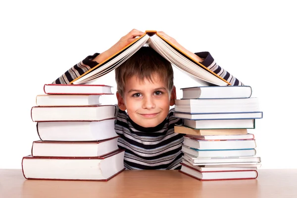 Colegial y un montón de libros — Foto de Stock