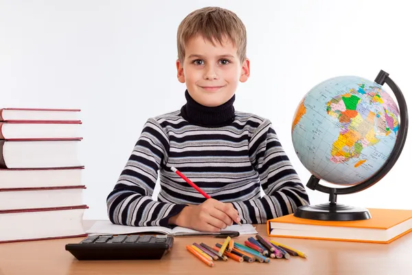 Cute schoolboy is writting Stock Image