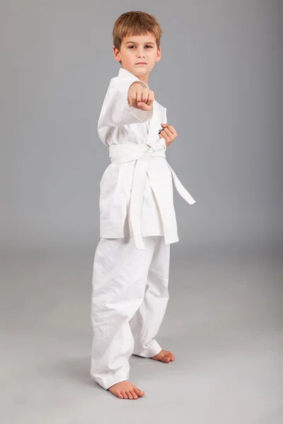 Karate boy in white kimono fighting — Stock Photo, Image