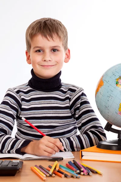 Cute schoolboy is writting Royalty Free Stock Photos