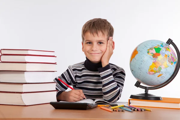 Cute schoolboy is writting Royalty Free Stock Images