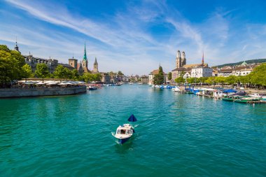 ZURICH, SWITZERLAND - JULY 25, 2017: Historical part of Zurich with famous Fraumunster and Grossmunster churches in a beautiful summer day, Switzerland clipart