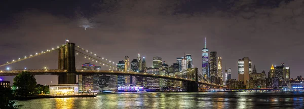 美国纽约市的布鲁克林大桥全景和日落后曼哈顿市中心的全景夜景 — 图库照片