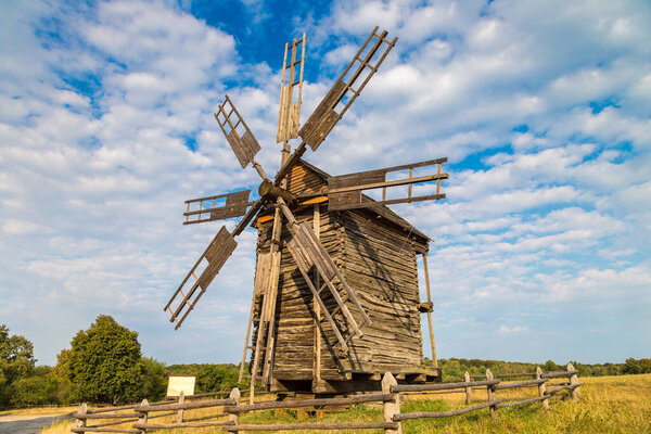 Traditional ukrainian windmill in the museum of national architecture in Pirogovo in a beautiful summer day, Kiev, Ukraine